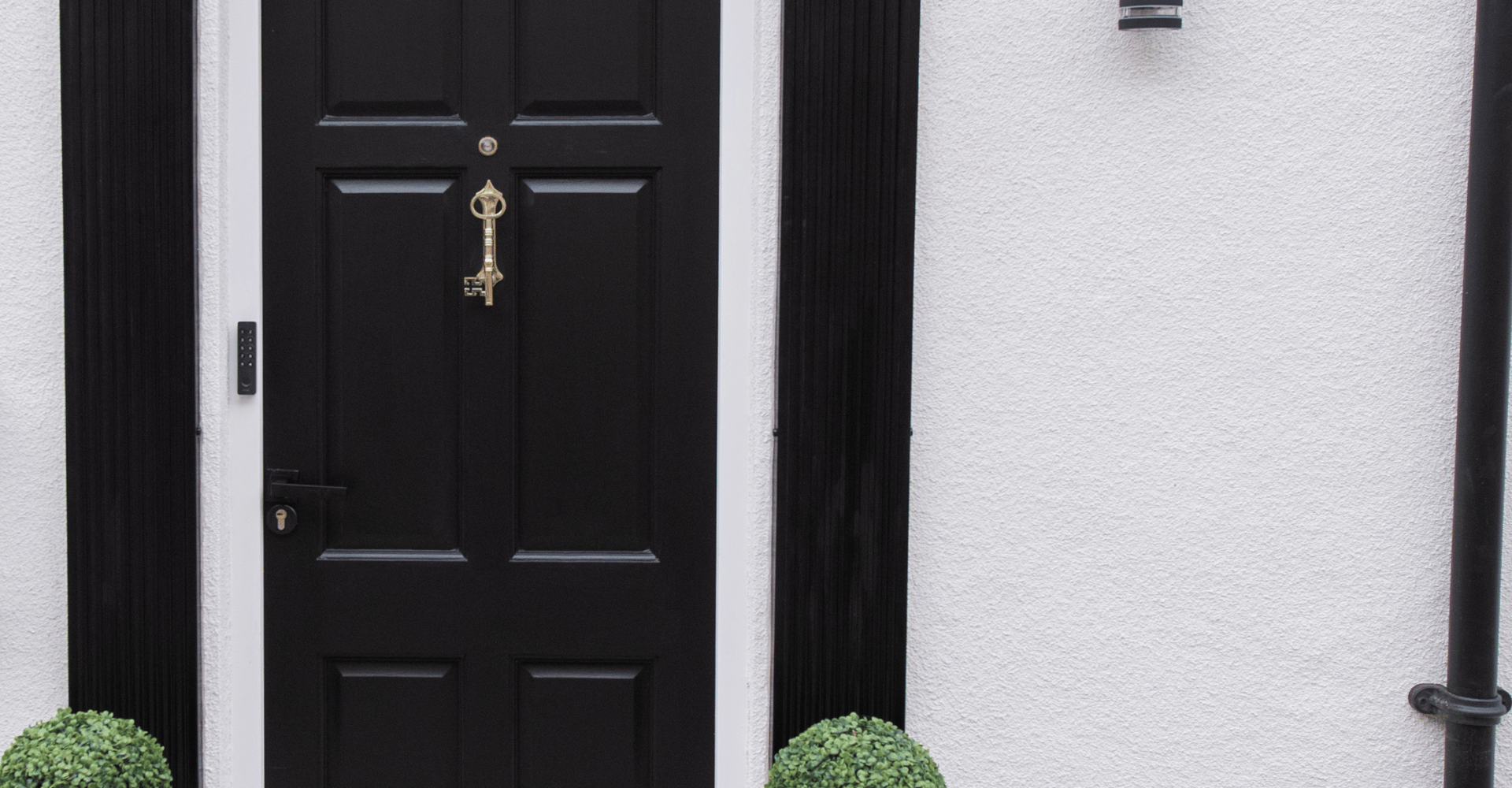 The Malt House black front door with gold key knocker