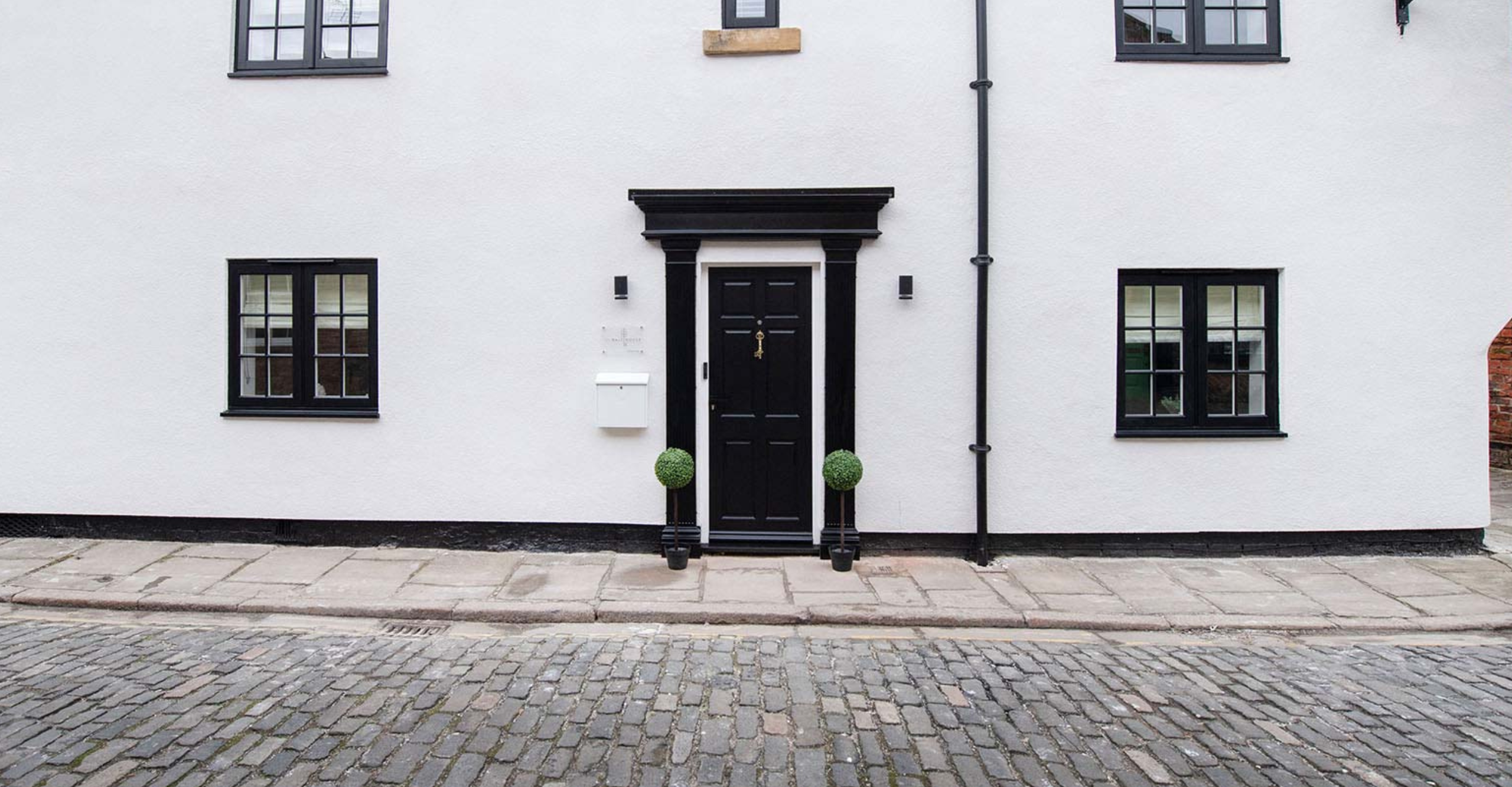 The black and white front of The Malt House, Howden